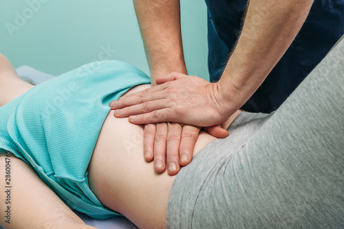 macro close up of therapist applying pressure on stomach detail of hands massaging female belly