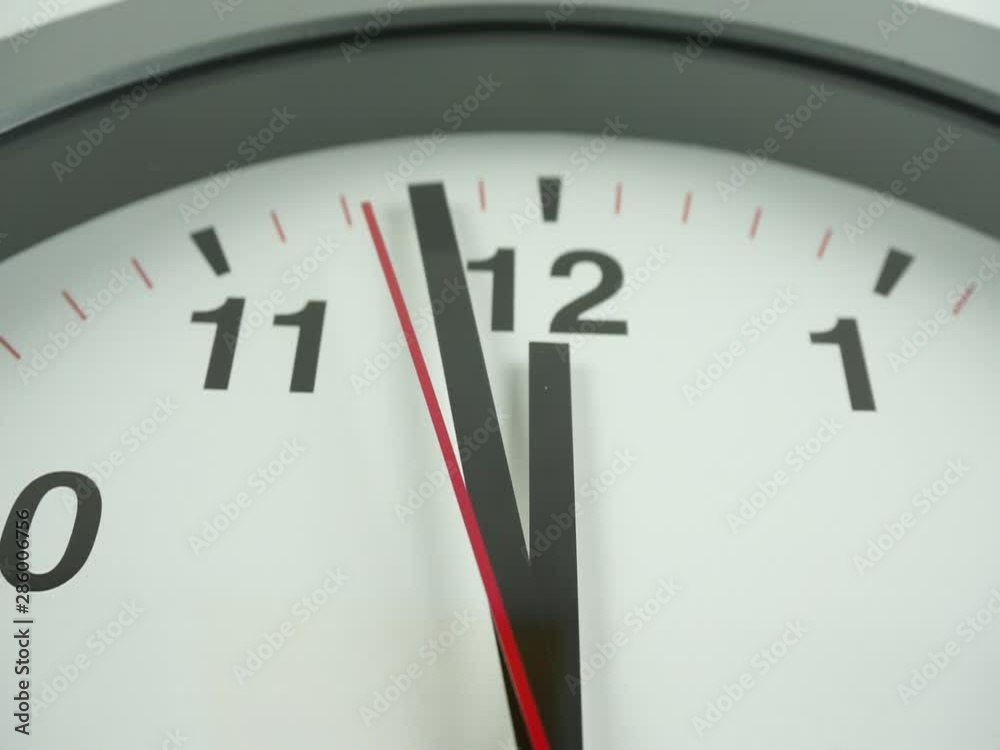 White wall clock face beginning of time 11.58 am or pm, Clock minute walk slowly, Time concept. White wall clock face beginning of time 11.58 am or pm, Clock minute walk slowly, Time concept.