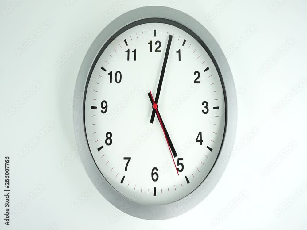 Closeup White wall clock face beginning of time 12.00 am or pm, Clock minute walk slowly, Time concept. Closeup White wall clock face beginning of time 12.00 am or pm, Clock minute walk slowly, Time concept.