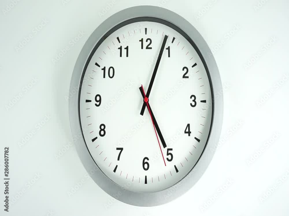 Closeup White wall clock face beginning of time 12.00 am or pm, Clock minute walk slowly, Time concept. Closeup White wall clock face beginning of time 12.00 am or pm, Clock minute walk slowly, Time concept.