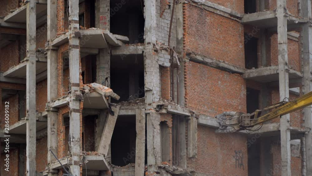 demolition of a multi-storey building with hydraulic shears, for future development of residential buildings demolition of a multi-storey building with hydraulic shears, for future development of residential buildings