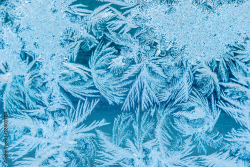 New Year and Christmas abstract icy frost cold weather snowy blue background with real ice crystals macro