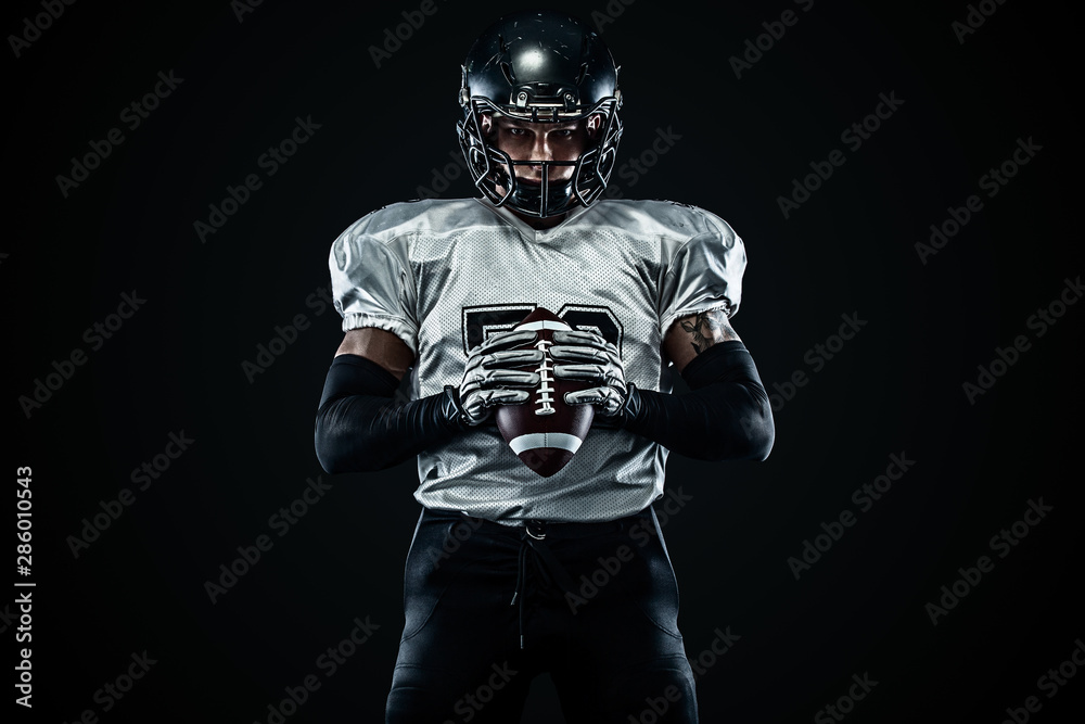 American football sportsman player in helmet on black background. Sport and motivation. Team sports.