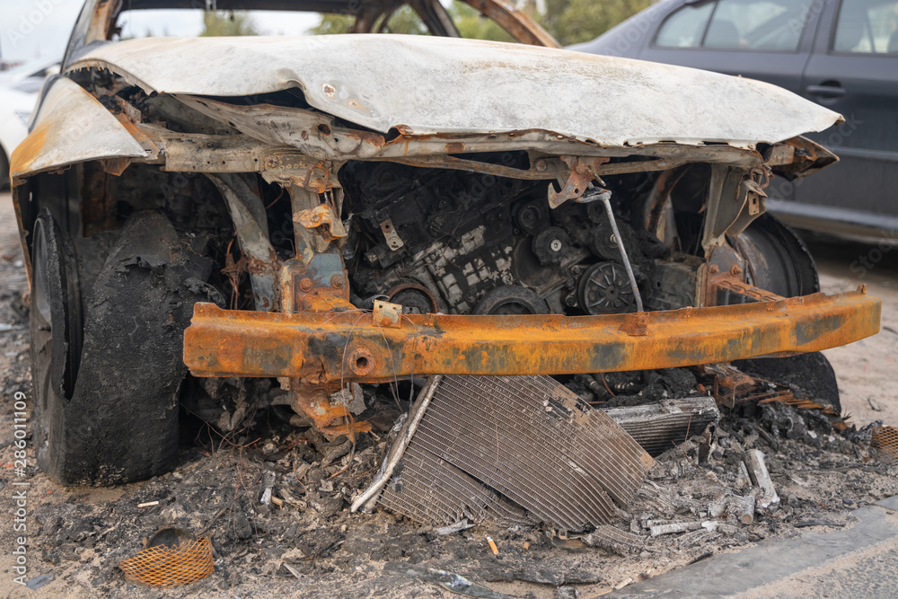 car after deliberate arson. destroyed vehicle after a fire melted is on the street. car after deliberate arson. destroyed vehicle after a fire melted is on the street.