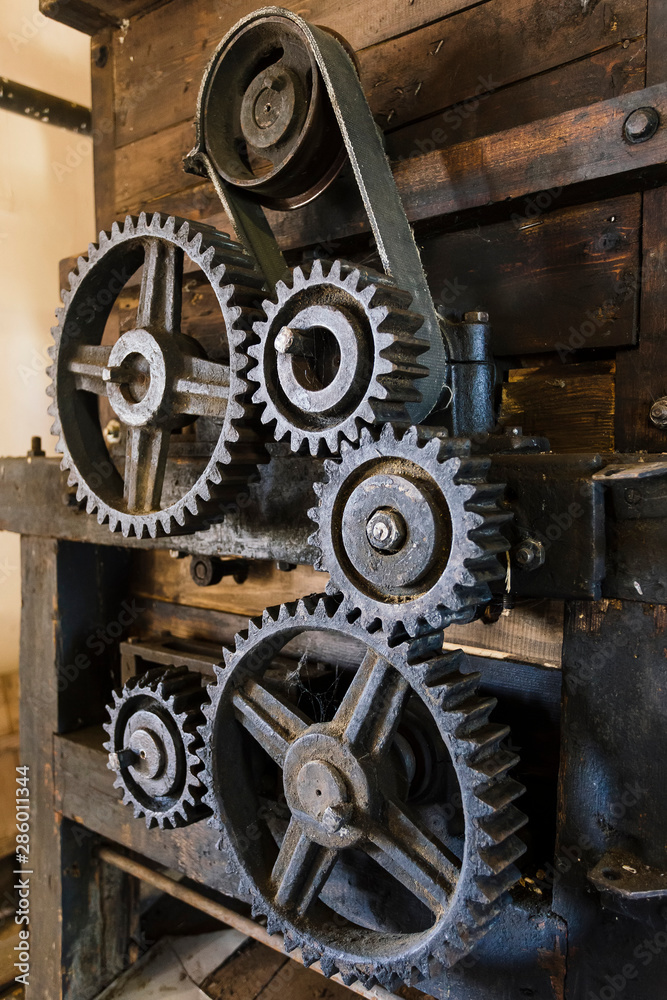 Old mechanism. Old gears and pulleys with belt