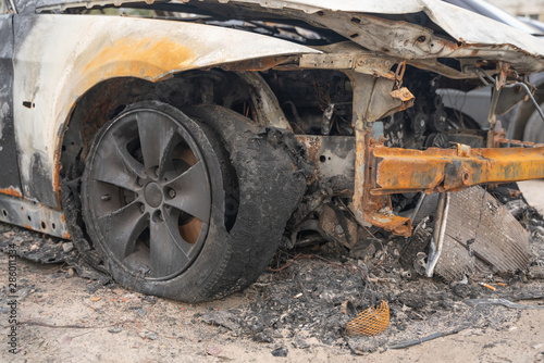 car after deliberate arson. destroyed vehicle after a fire melted is on the street. © goldeneden