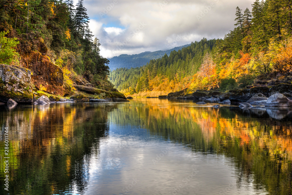 A rainbow of fall colors is reflected in the smooth Rogue River while white water rafting with some amazing friends