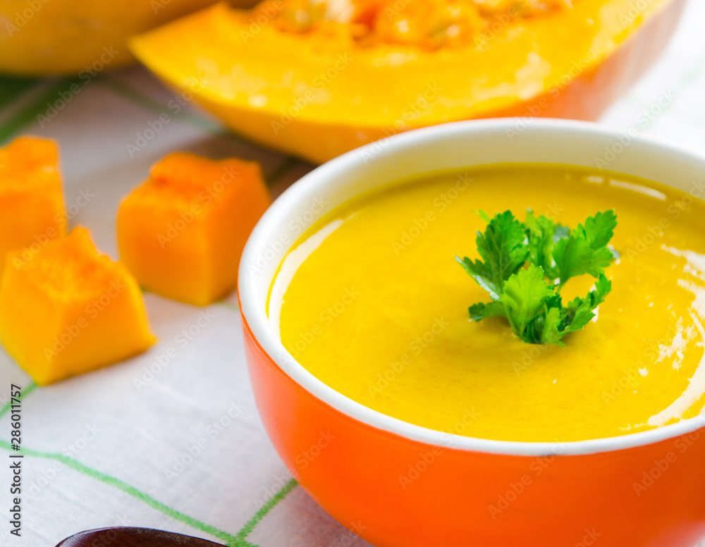 Pumpkin soup served on the table in bowl Pumpkin soup served on the table in bowl