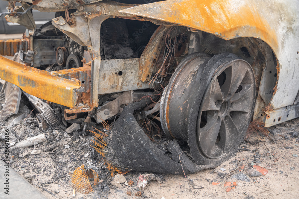 car after deliberate arson. destroyed vehicle after a fire melted is on the street. car after deliberate arson. destroyed vehicle after a fire melted is on the street.