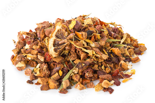 Heap of dried fruit tea infusion with oranges and strawberries mixed with tea leaves and herbs over white background