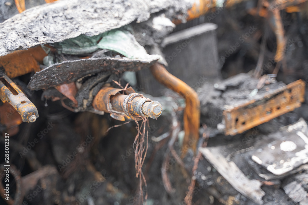 Fototapeta premium crushed melt car after deliberate arson. destroyed vehicle after a fire melted is on the street.