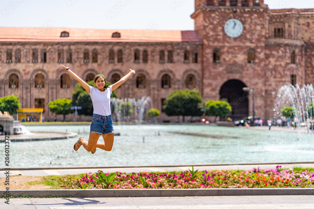 Happy tourist girl travelling in Armenia taking selfie photo in Yerevan city.