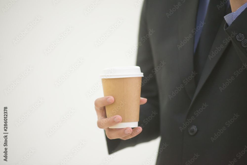 Attractive businessman holding a coffee cup Attractive businessman holding a coffee cup