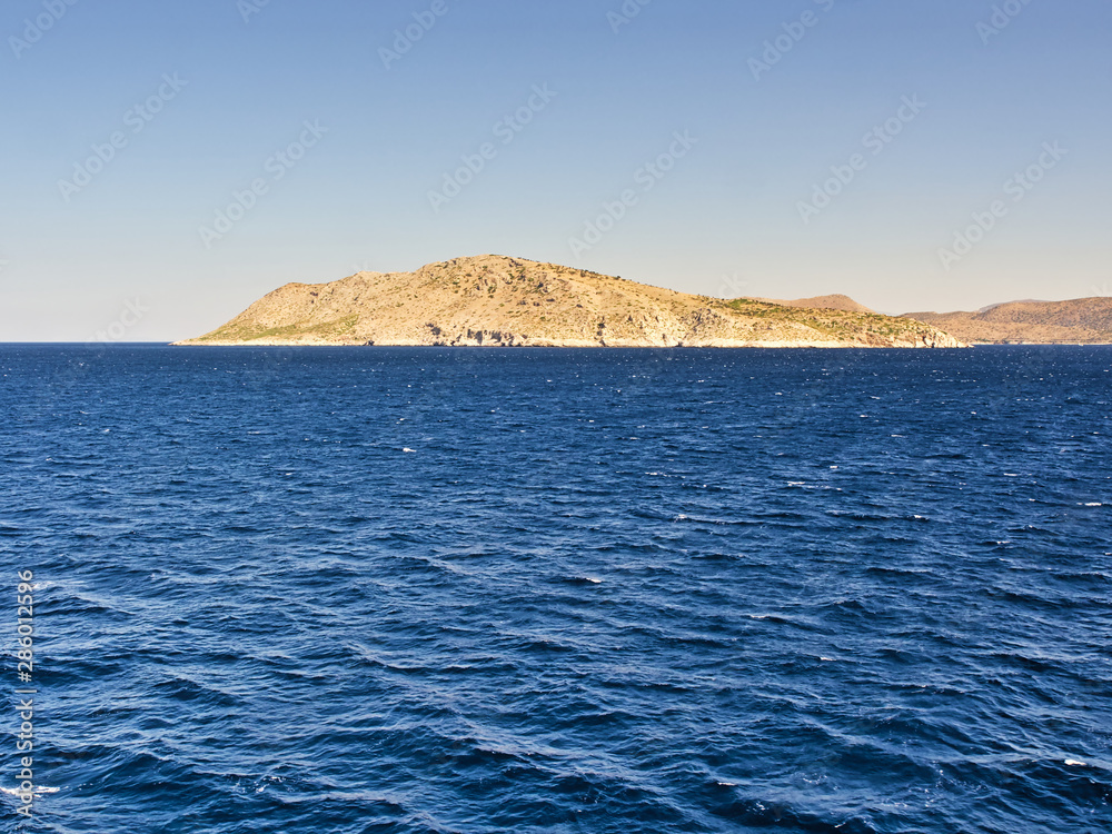 Uninhabited island and deep blue sea.