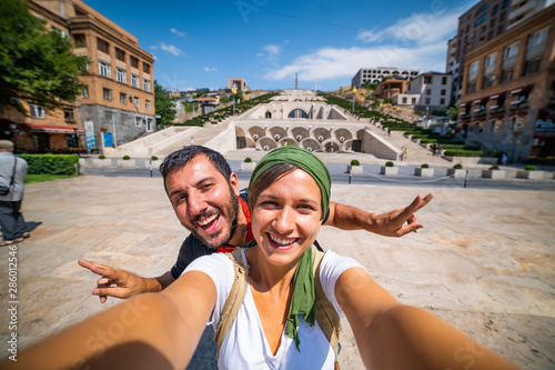Happy tourist travelling in Armenia taking selfie photo in Yerevan city.