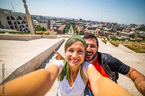 Happy tourist travelling in Armenia taking selfie photo in Yerevan city.