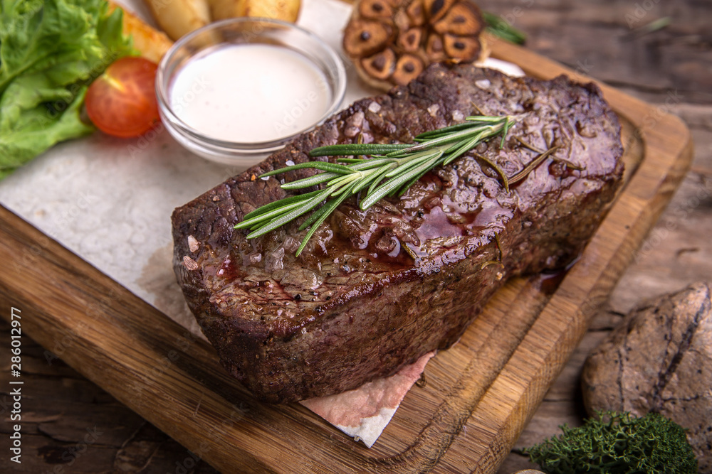 Neck steak, tenderloin or filet mignon pork or beef. Juicy tasty piece of meat. Delicious juicy steak. A big piece of grilled meat. Neck steak, tenderloin or filet mignon pork or beef. Juicy tasty piece of meat. Delicious juicy steak. A big piece of grilled meat.