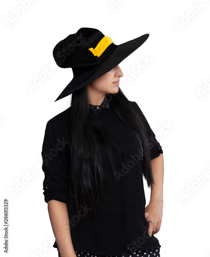 Portrait of young woman in witch costume isolated on white background. Halloween theme on white