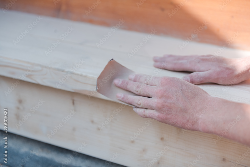Sand the wood with sandpaper. A man polishes a tree. Work with sandpaper. To make wooden products. Make boards smooth. Sand the wood with sandpaper. A man polishes a tree. Work with sandpaper. To make wooden products. Make boards smooth.