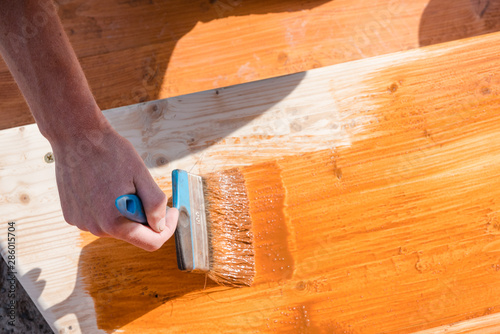 Paint the porch with orange paint. Decorate the terrace. Paint the boards with a wide brush. To make repairs.
