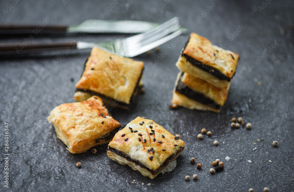 sesame puff served on dark plate in traditional oriental