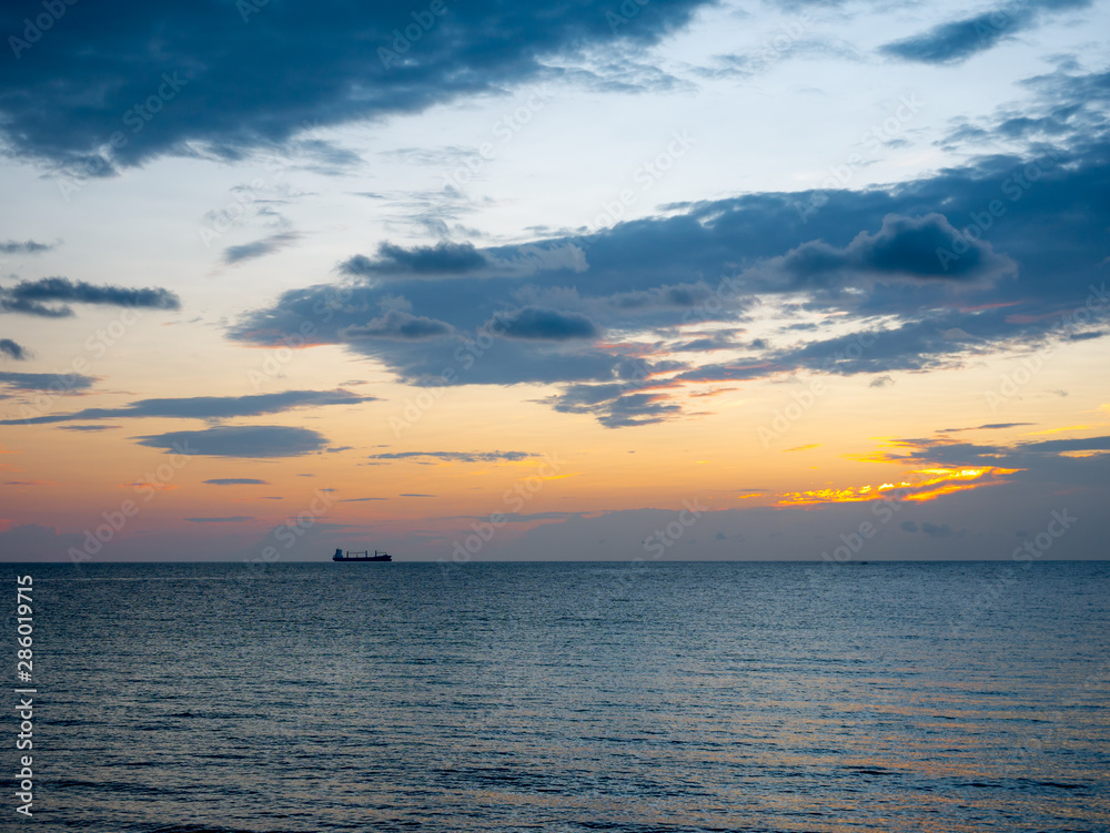 A distant ship in the Atlantic Ocean, Florida, during sunset