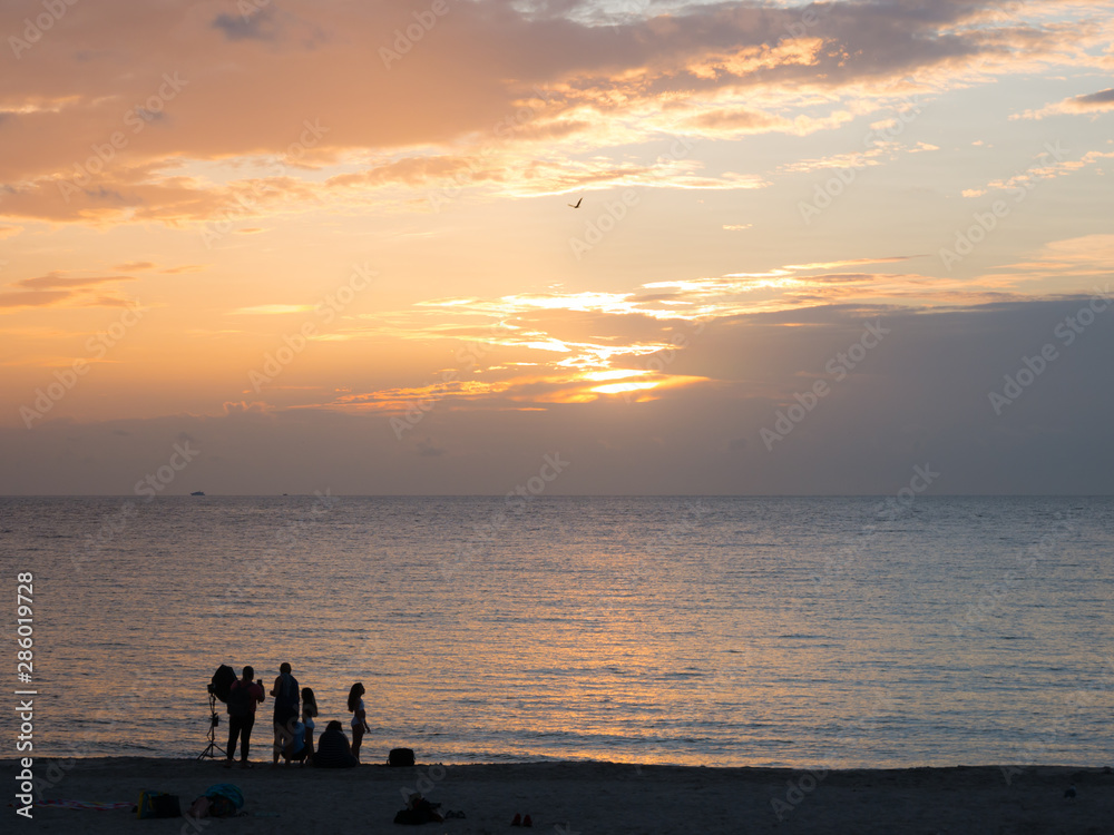 Miami beach, Florida, USA. August 2019. People relaxing during the sunset in South Beach. South Beach is famous for its tropical sea, the long white beaches and nightlife.