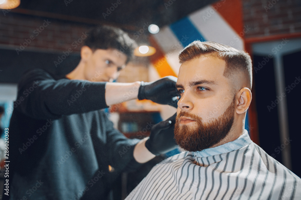 Man with a beard. Hairdresser with a client. Man with a beard. Hairdresser with a client.