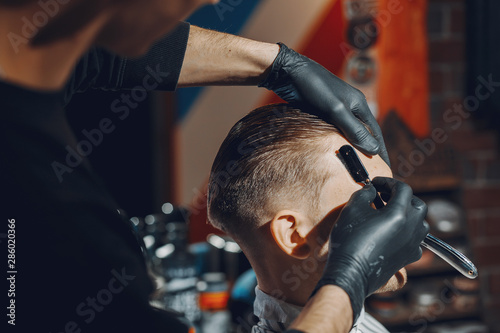 Man with a beard. Hairdresser with a client.