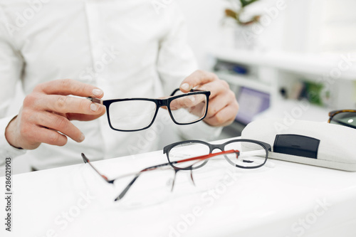 Man in a glasses. Guy in a optics shop