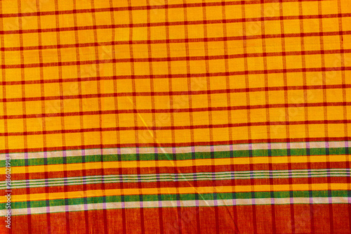 Green, Yellow, red and black strip cotton Gamcha(Bath towel) Fabrics Close-up. photo