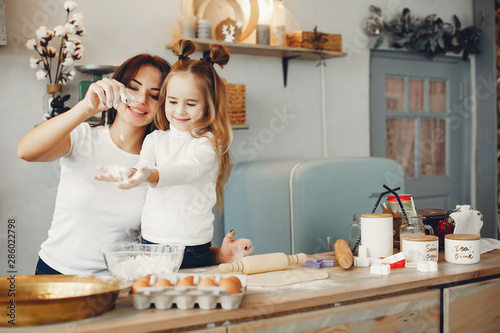 Family in a kitchen. Beautiful mother with little daughter