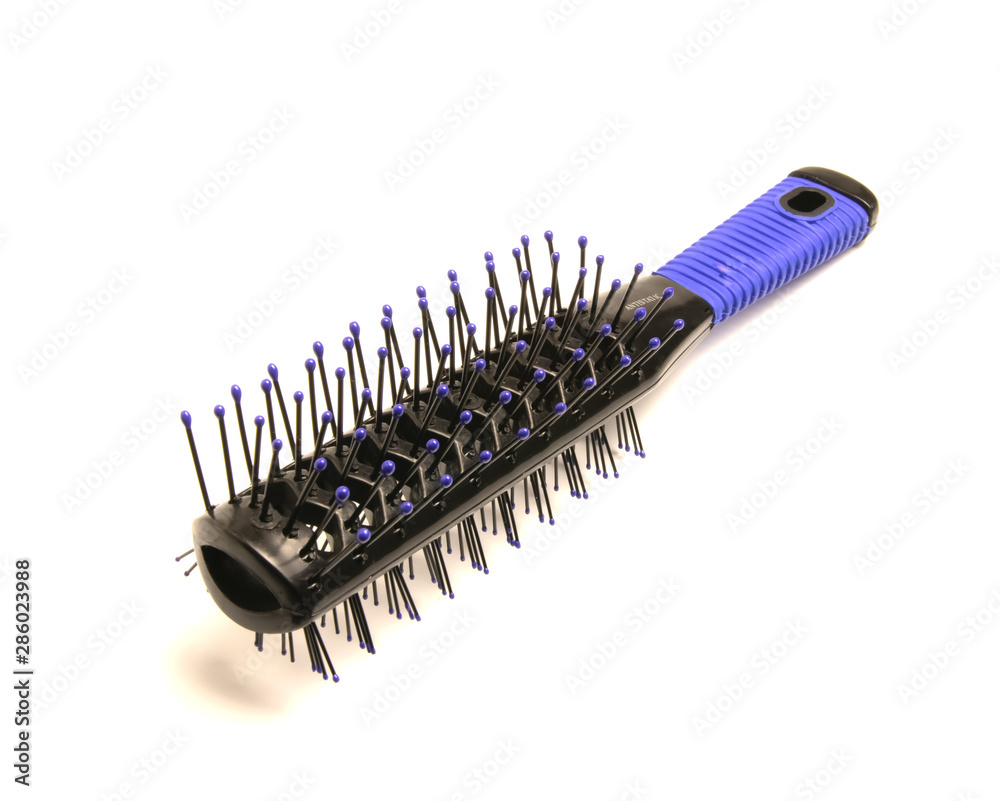 black and blue massage comb lies on a white background black and blue massage comb lies on a white background