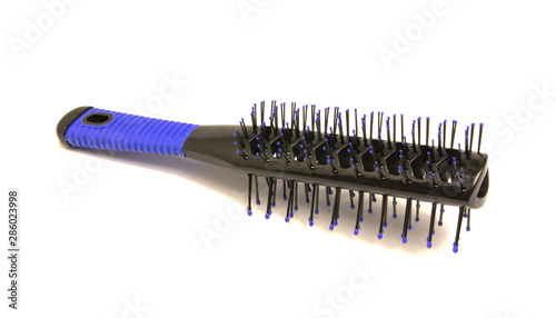 black and blue massage comb lies on a white background