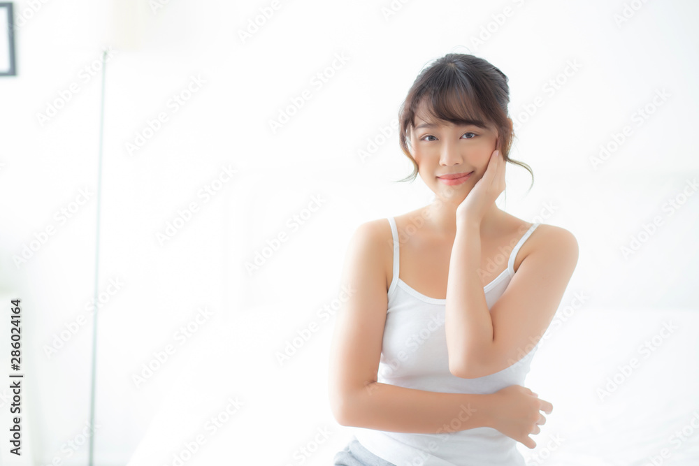 Portrait of beautiful young asian woman smile while wake up healthy and wellness with sunrise at morning in the bedroom, asia girl skin care with happy with fresh, lifestyle and relax concept. Portrait of beautiful young asian woman smile while wake up healthy and wellness with sunrise at morning in the bedroom, asia girl skin care with happy with fresh, lifestyle and relax concept.