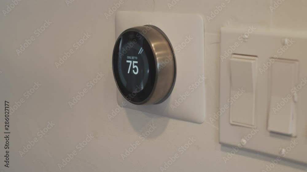 Adjusting the temperature on a smart thermostat. Adjusting the temperature on a smart thermostat.