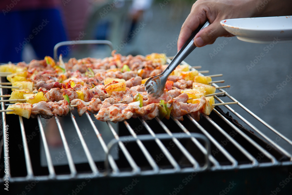 Barbeque Grill Street Food in thailand,Eat outdoors in a happy family. holiday celebration concept Barbeque Grill Street Food in thailand,Eat outdoors in a happy family. holiday celebration concept