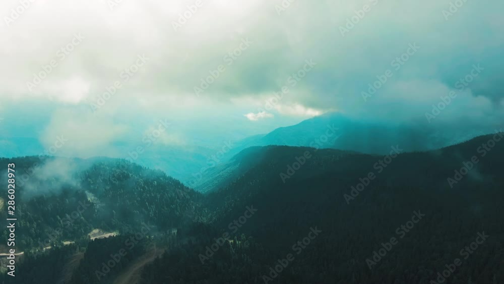 Aerial 4k view. Flying through the clouds above mountain tops. High peaks wonderful morning sunrise natural Landscape. Aerial 4k view. Flying through the clouds above mountain tops. High peaks wonderful morning sunrise natural Landscape.