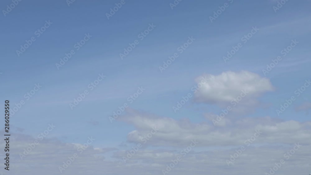 Timelapse of clouds moving and rolling on a blue and sunny sky. Summer time, western Europe Timelapse of clouds moving and rolling on a blue and sunny sky. Summer time, western Europe