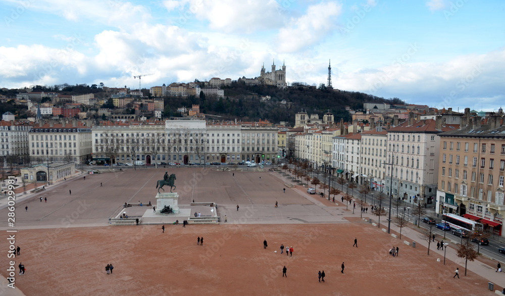 Aerial view on Lyon city and the bigest square in Europe Bellecour Square as well as on Basilica of Notre-Dame de Fourvière. City center view.