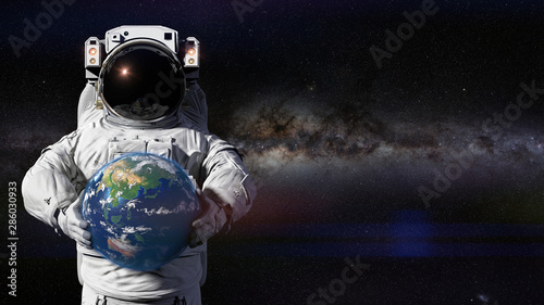 Fototapeta Naklejka Na Ścianę i Meble -  astronaut holding planet Earth featuring Asia, Oceania and Australia
