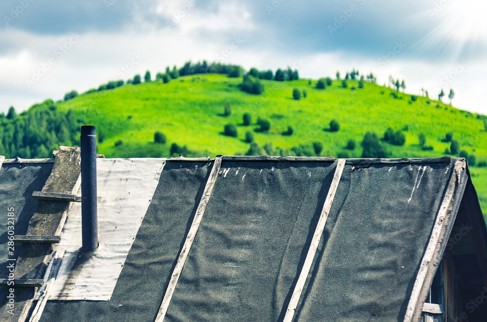 Rooftop Covered with Waterproofing Tar Paper, Wooden Ladder and Metal