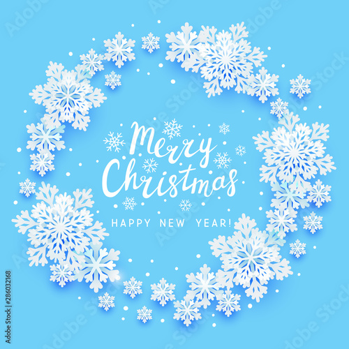 Christmas greeting card with paper snowflakes round frame on blue background for Your holiday design