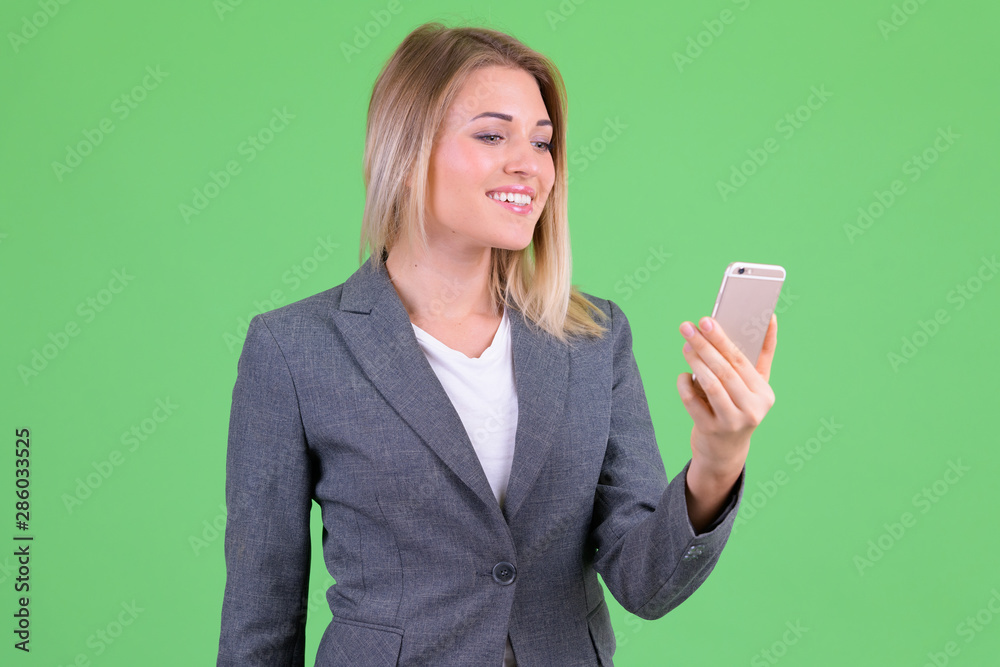 Happy young beautiful blonde businesswoman using phone Happy young beautiful blonde businesswoman using phone