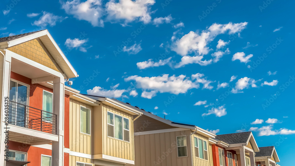 Panorama Top exterior of homes with balconies and combination of orange and white wall Panorama Top exterior of homes with balconies and combination of orange and white wall