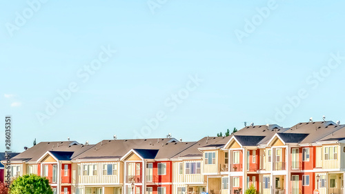 Panorama frame Blue sky on a sunny day over townhomes with white and red exterior wall