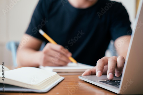 Closeup man hands using computer laptop.