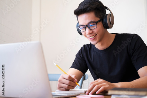 Young man student study at home using laptop and learning online.