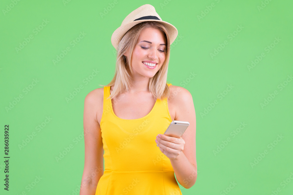 Happy young beautiful blonde tourist woman using phone Happy young beautiful blonde tourist woman using phone