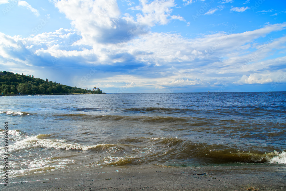 Surging wave on the Kyiv sea reservoir, water reflection, foam and sun beam